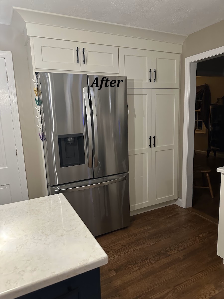 Completed Braley kitchen remodel with white shaker cabinets, quartz countertops and a navy island.