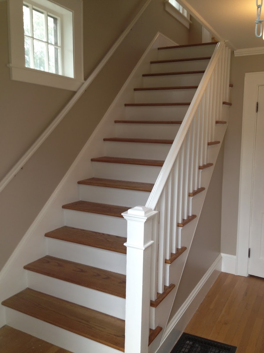 Rebuilt staircase with oak treads, painted white risers and turned balusters.